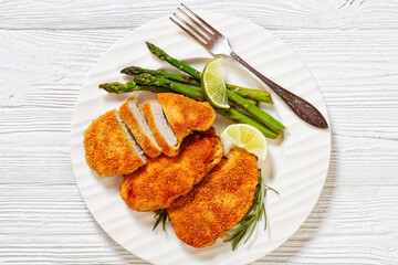 breaded chicken breasts with asparagus and lime