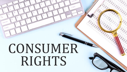 CONSUMER RIGHTS text on blue background with keyboard and clipboard, business concept