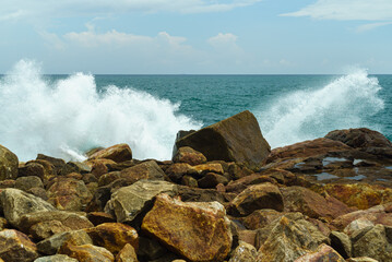 Rocky shore of the ocean and splashes from the waves