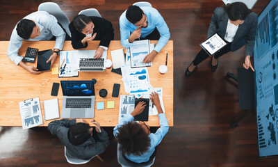 Top view business presentation with data analysis dashboard on TV screen in modern meeting room. Business people brainstorming or working together to plan business marketing strategy. Concord