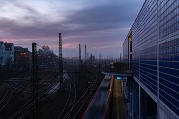 Long railroad near buildings at dusk with the sky behind in Hannover