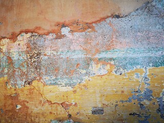 Abstract, Texture and Grunge Background of color stain, green, yellow, pink peeling paint on old concrete wall.