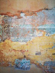 Abstract, Texture and Grunge Background of color stain, green, yellow, pink peeling paint on old concrete wall.