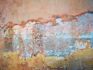 Abstract, Texture and Grunge Background of color stain, green, yellow, pink peeling paint on old concrete wall.