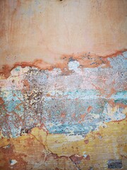 Abstract, Texture and Grunge Background of color stain, green, yellow, pink peeling paint on old concrete wall.