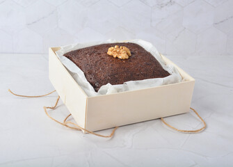 premium freshly baked dark cocoa chocolate brownie square cake with walnut in wood bento box on...