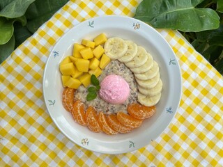 Oat overnight milk with strawberry Greek yogurt with orange, mango and banana