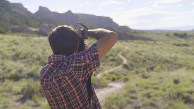 Photographer taking pictures of the beautiful landscape in the USA on a sunny day