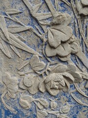 Detail of a old historic stone relief seen at the Garden in Shanghai (China)