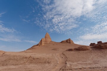 Fototapeta na wymiar Breathtaking desert landscape featuring tall, red-hued rock formations against a bright blue sky