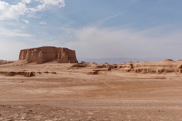 Fototapeta na wymiar Breathtaking desert landscape featuring tall, red-hued rock formations against a bright blue sky