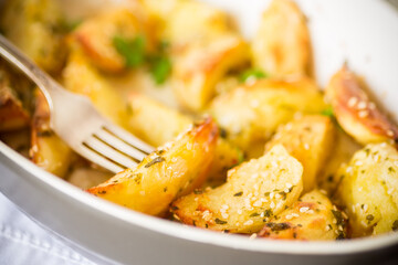potatoes baked with sesame seeds, herbs and spices in the oven