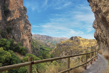 Fototapeta na wymiar A Bridge on the Edge of a Cliff with Nature Sight in Los Cahorros, Granada, Spain