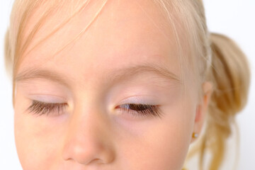 close up part human eyes of little child 3 years old, blonde girl looking, squinted eyes, concept...
