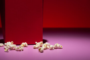 Popcorn scattered at the base of the red bowl that contained it.