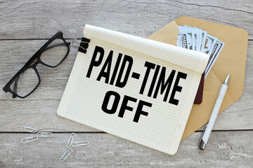 Paid time off open notepad with text on an envelope with money