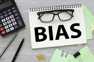 Bias - word from wooden blocks with letters, personal opinions prejudice bias concept, random letters around, white background