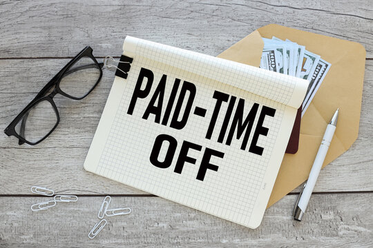 Paid time off open notepad with text on an envelope with money