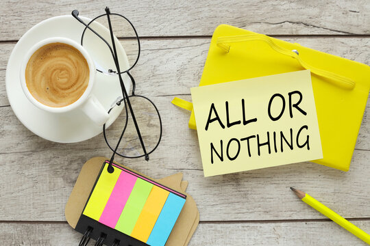 OLL OR NOTHING. acronym text, business concept. text on yellow sticky note on yellow notepad near coffee cup