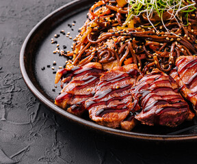 Soba beef and vegetables, Buckwheat noodles on a dark stone background