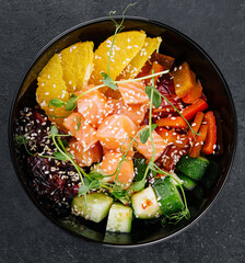 Poke bowl with salmon, cucumber, pepper and orange