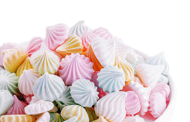 Small colorful meringues in the ceramic plate