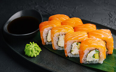 Fresh delicious philadelphia sushi on black plate