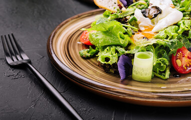 Vegetable salad with poached egg on a plate