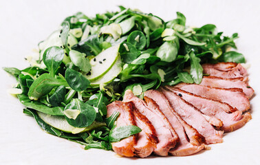 pieces of fillet of duck with salad