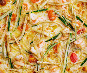 Thin-crust pizza dough with shrimps and zucchini