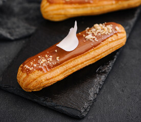 Traditional french dessert. eclair with caramel