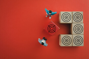 Business Target,Goal concept.,Businessman focus on red wooden cube with aiming at the target icon...