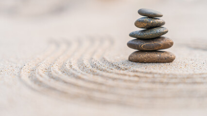 Fototapeta na wymiar zen stones on the sand beach