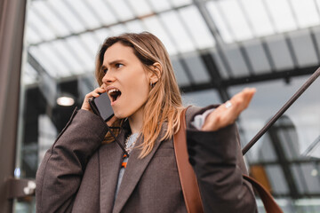 Business woman caucasian girl lady female talking using mobile phone feels shock upset worries...