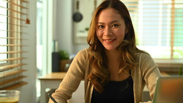 Young smiling female nutritionist working on diet plan at office. Right nutrition, wellness and healthy lifestyle concept. Dolly in shot