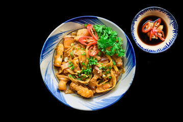 Vietnamese fried pork with noodle and ginger on black background