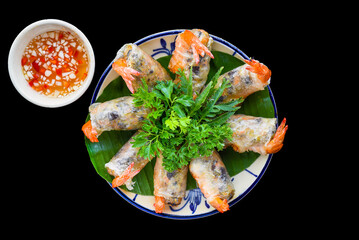 Traditional fried vietnamese spring rolls with shrimps and pork, rice paper on black background