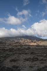 Landscape with mountains in the background and a cloudy evening day