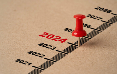 Red pin on paper with 2024 year for preparation merry Christmas and happy new year concept.