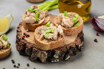 Rye Bread cod liver spread. Sandwich with cod liver on rye bread on a wooden board. place for text, top view