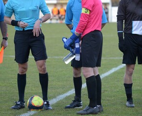 capitaine et arbitres au football