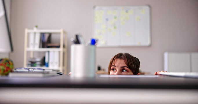 Scared Woman Hiding Behind Chair
