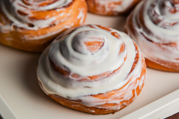 Sweet buns covered with white cream. Confectionery.