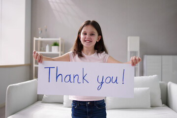 Smiling Girl Holding Thank You Sign Against White