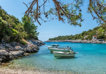Small old boats on crystal clear turquoise water at Rasohatica beach on Korcula island in Croatia