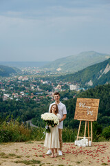 Portrait of a young couple after a marriage proposal in the mountains