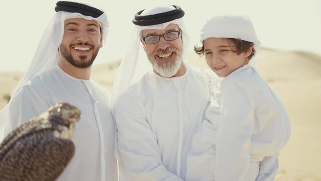 Three generation family spending time in the desert making a safari in Dubai. Concept about middle eastern cultures and lifestyle in the emirates