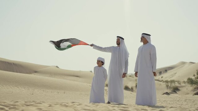 Three generation family spending time in the desert making a safari in Dubai. Concept about middle eastern cultures and lifestyle in the emirates