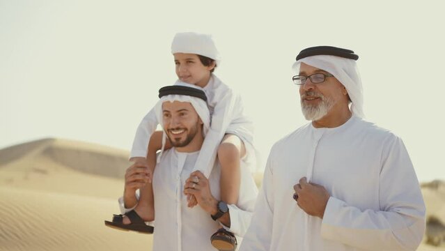 Three generation family spending time in the desert making a safari in Dubai. Concept about middle eastern cultures and lifestyle in the emirates