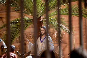 The sculptures of a nativity scene behind a fence in Astorga, Spain during holy week